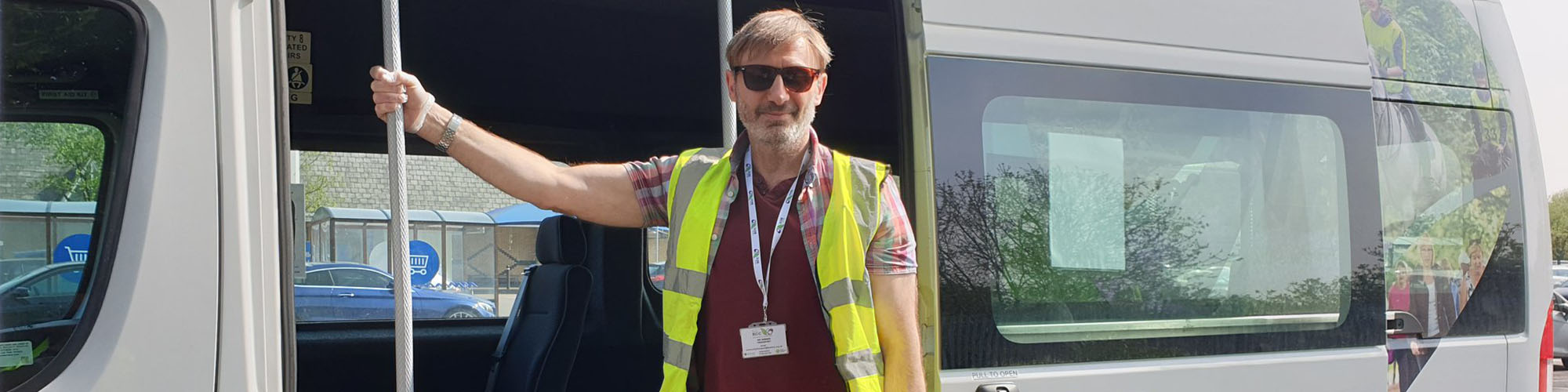 A smiling Door 2 Door minbus driver