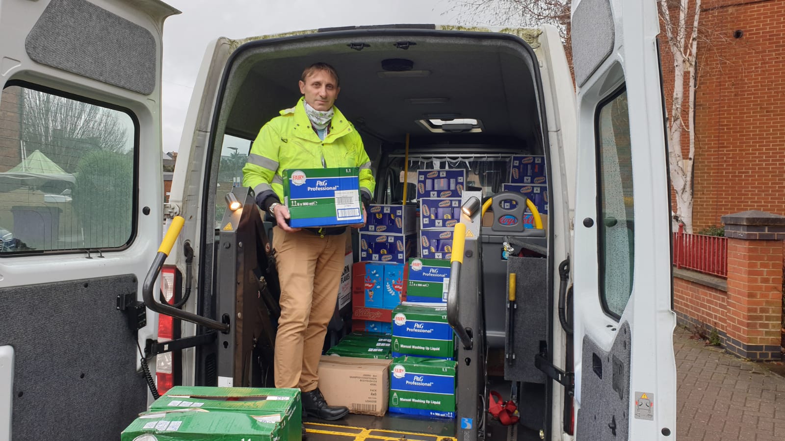 Community transport bus and driver delivering supplies