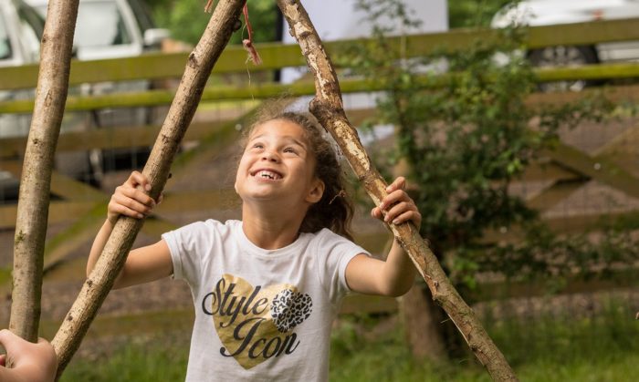Little girl holding sticks