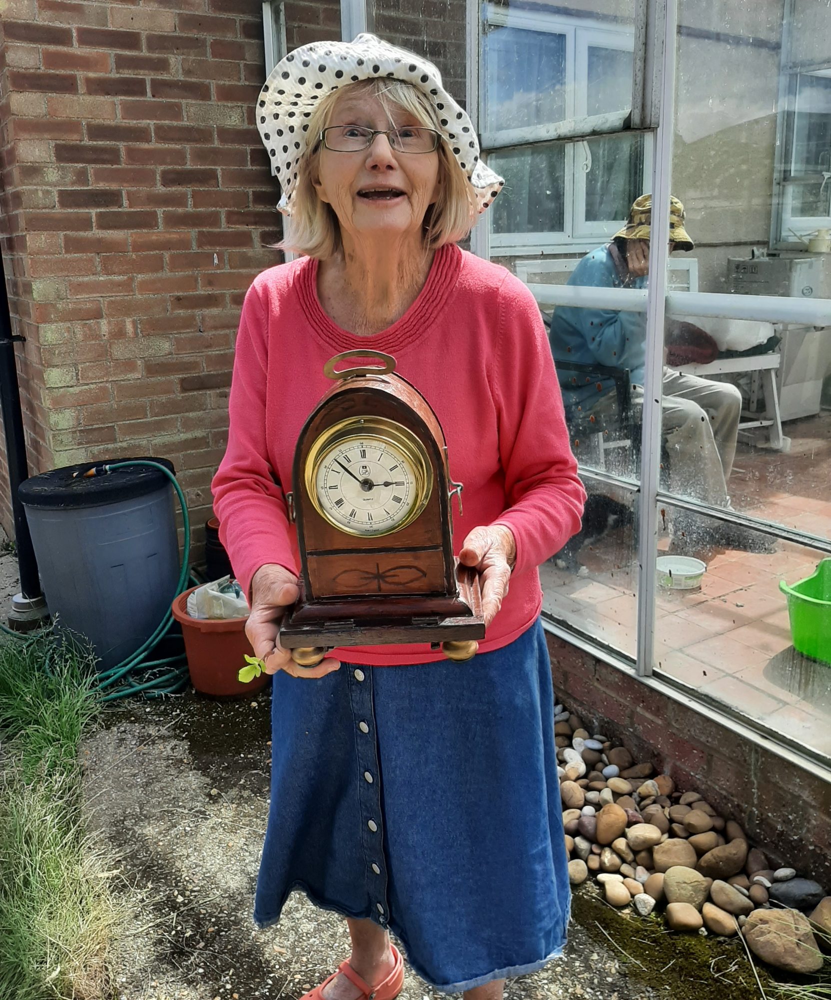 Mrs A holding her repaired clock