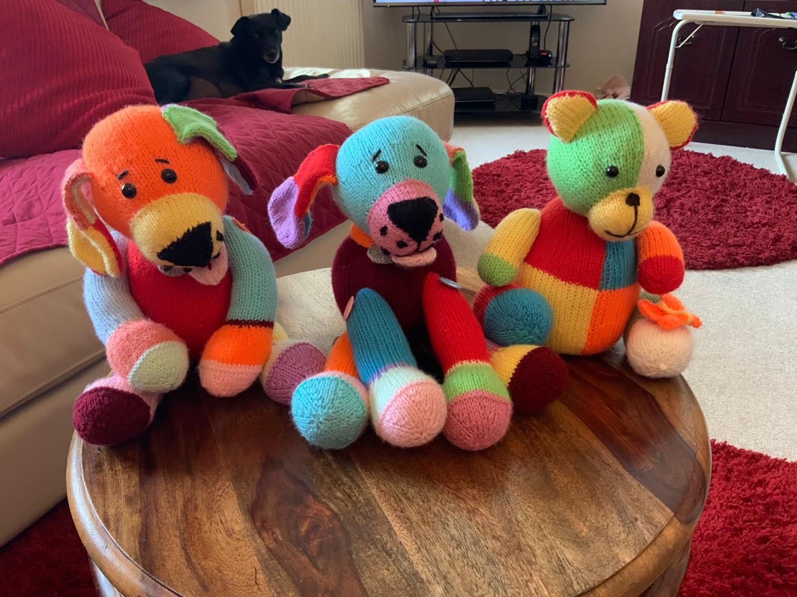 3 Knitted teady bears sitting on coffee table