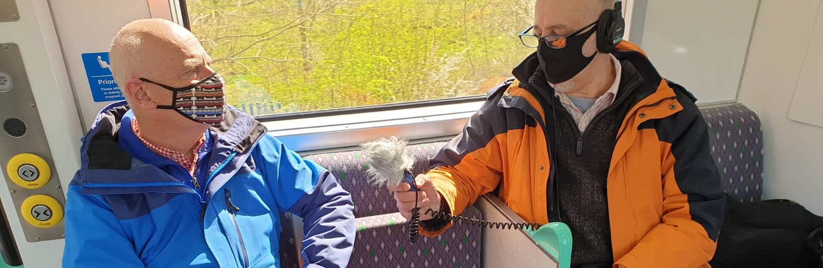 Man being interviwed in a train